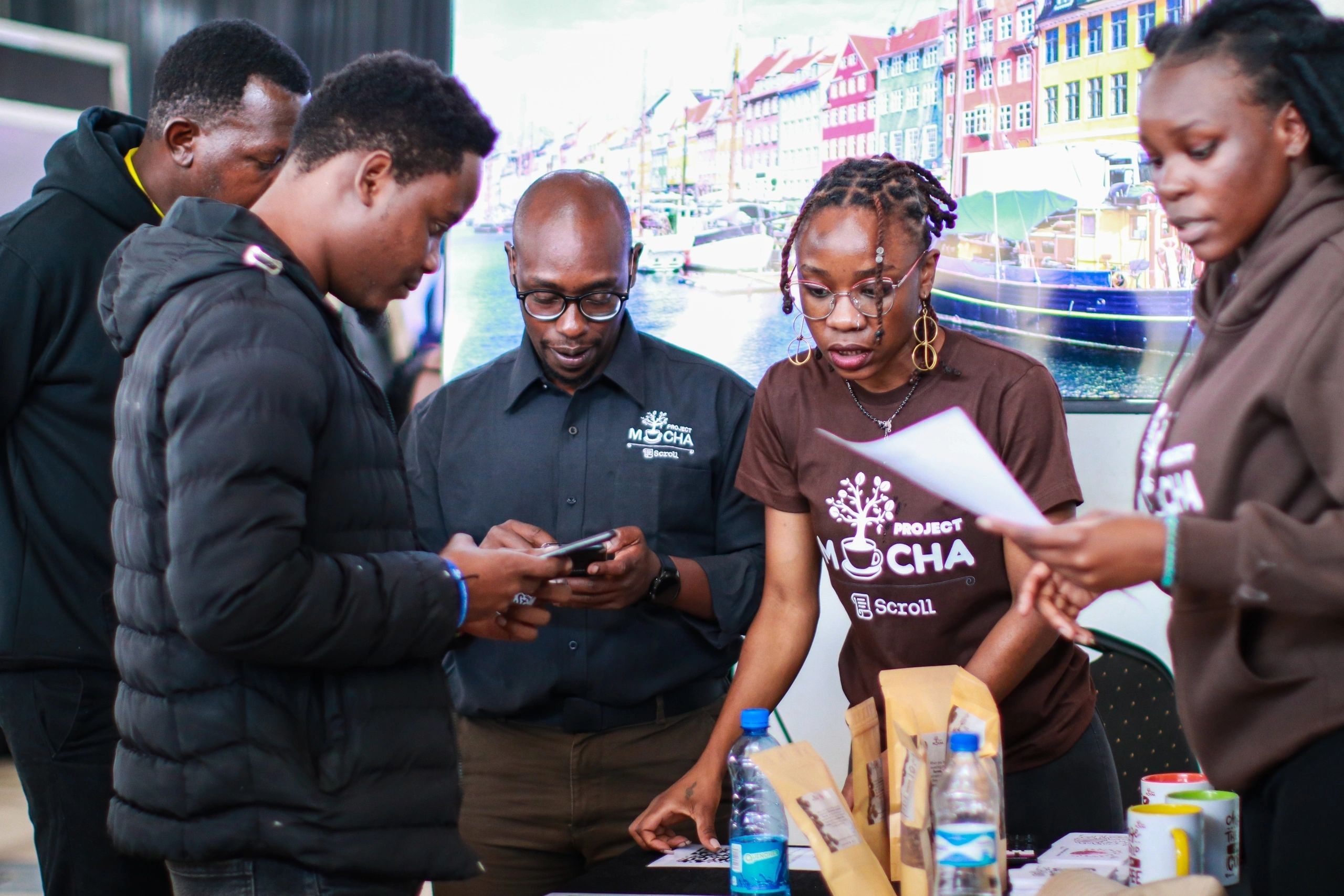 Project Mocha team members working with coffee products and digital tools